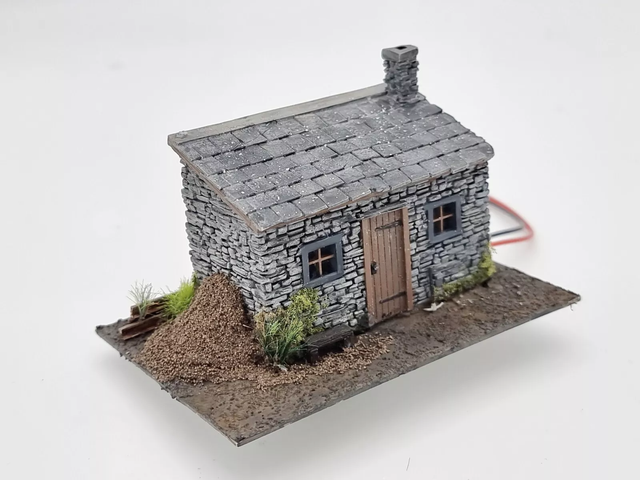 OO gauge model railway lineside hut with moss, ivy and creeping vegetation