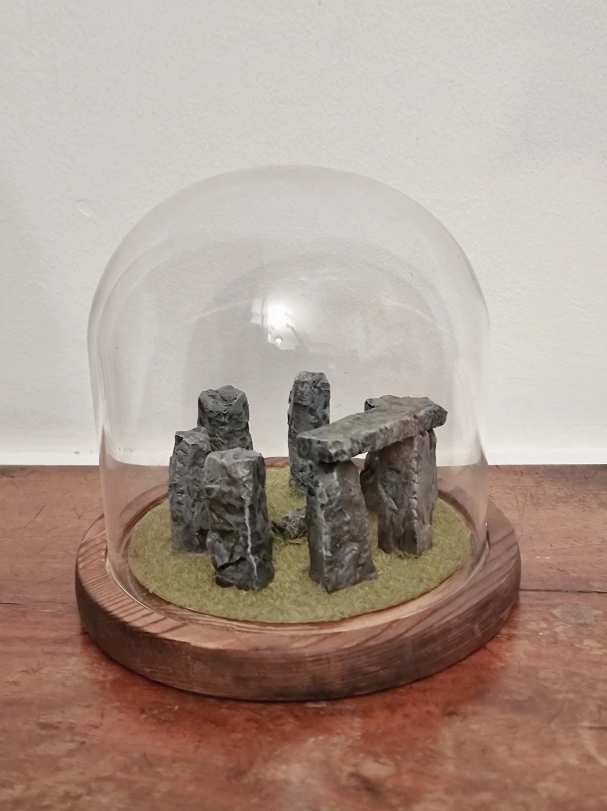 Miniature Stonehenge diorama in a glass dome